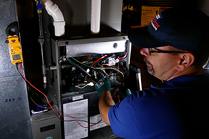 Betlem HVAC Technician Testing A Furance With A Metering DEvice