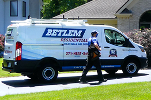 Betlem service van in home driveway walking from it to front door
